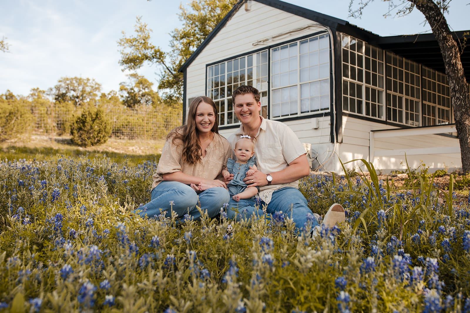 Loving family portrait surrounded by blooming bluebonnets in Bulverde