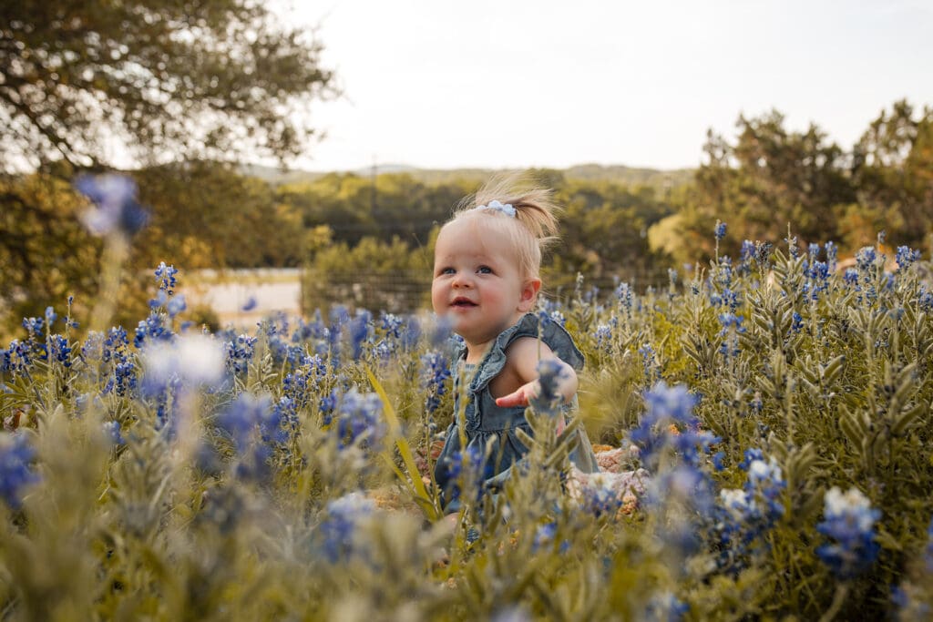 Close-up of baby sitting in bluebonnets during Bulverde family session

