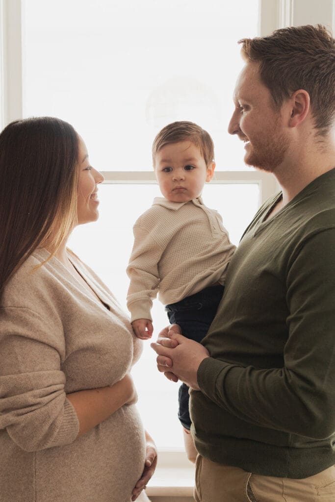 Playful indoor maternity moment in cozy home setting