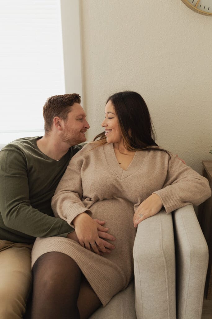 Relaxed pregnancy photo taken in bright, natural light indoor space
